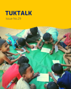 TukTalk Issue No. 29 cover with children lying on a green mat drawing on paper