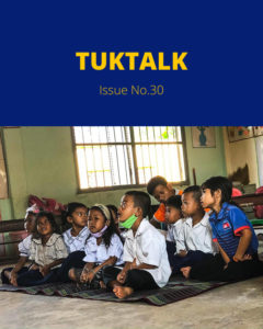 TukTalk Issue No. 30 cover with schoolchildren in uniform sitting on a mat in a classroom