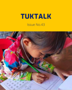 TukTalk Issue No. 43 cover with a young girl in a colourful top writing on a worksheet