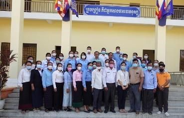 Participants from the education offices and target schools pose together for a group photo after the meeting