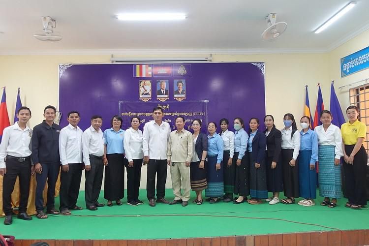 Education officials, principals and teachers line up on a stage for a group photo after the kick-off meeting