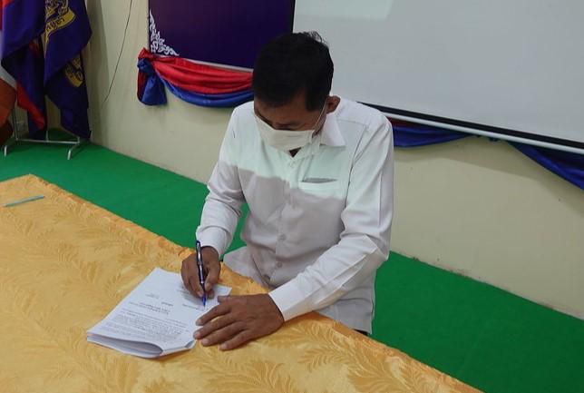 An education official signs the memorandum of understanding at the kick-off meeting