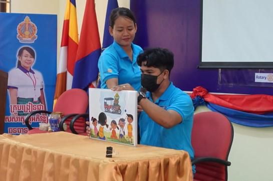 R4C staff tell a story with a Kamishibai picture stage to teachers at the first workshop