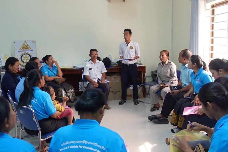 Teachers and officials sit in a circle for a group work discussion at the annual meeting