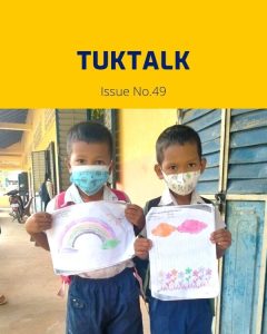Two children in face masks hold up their drawings of a rainbow and flowers