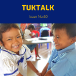 Two smiling kindergarten children in school uniform hold hands