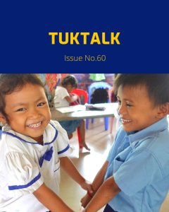 Two smiling kindergarten children in school uniform hold hands