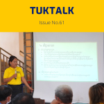 A TukTuk staff member in a yellow shirt presents slides at the annual meeting