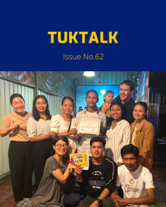 TukTuk staff and friends pose together at the New Year party, holding a certificate
