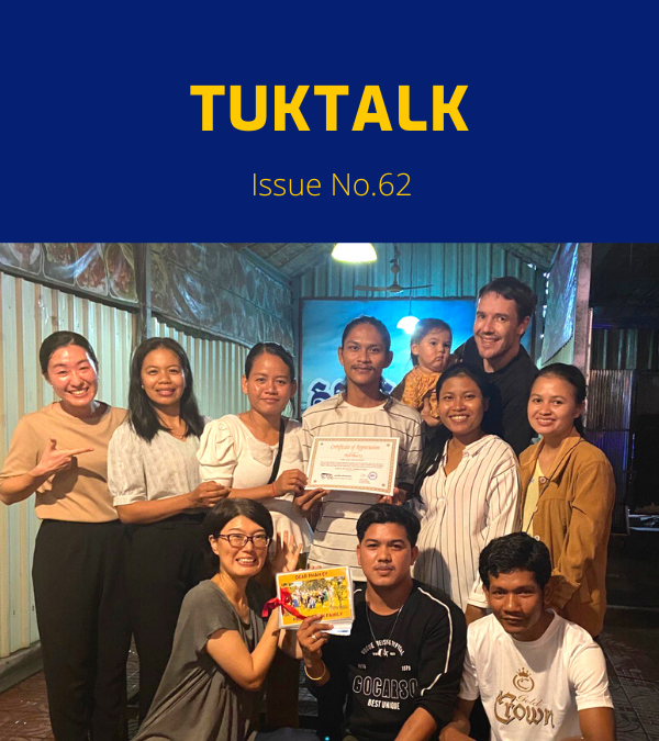 TukTuk staff and friends pose together at the New Year party, holding a certificate