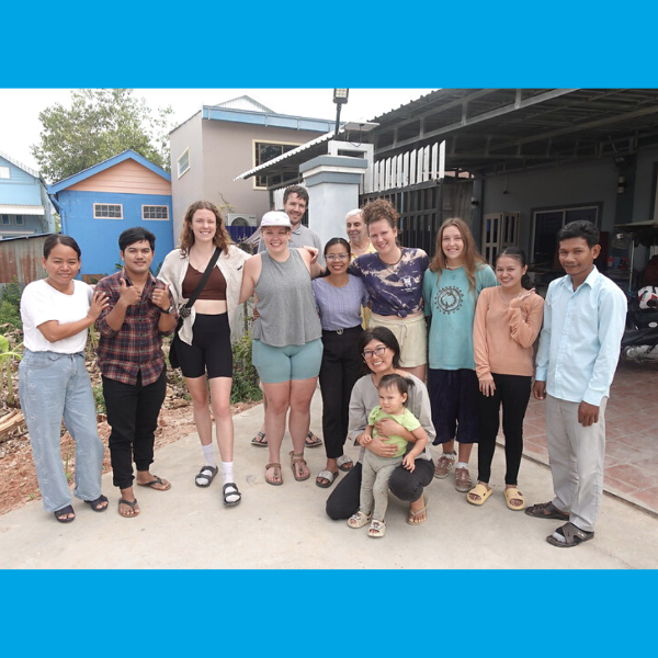 Voluntukers and TukTuk staff pose together outside for a group photo