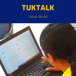 TukTalk 64 cover: a teacher types a worksheet on a laptop at the computer workshop