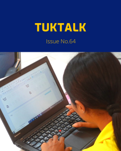 TukTalk 64 cover: a teacher types a worksheet on a laptop at the computer workshop