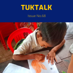 TukTalk 68 cover: a schoolboy colours a drawing with an orange pencil at a table in class