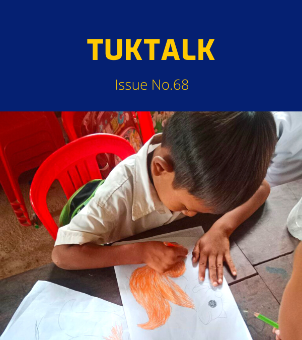 TukTalk 68 cover: a schoolboy colours a drawing with an orange pencil at a table in class