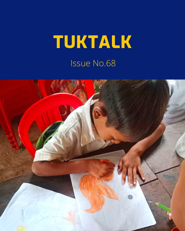 TukTalk 68 cover: a schoolboy colours a drawing with an orange pencil at a table in class