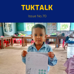 TukTalk 70 cover: a preschool boy holds up a Khmer letter worksheet in his classroom
