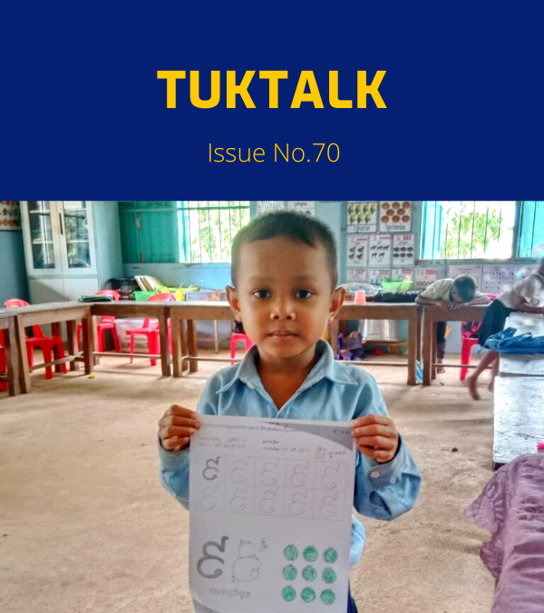 TukTalk 70 cover: a preschool boy holds up a Khmer letter worksheet in his classroom
