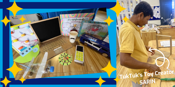 Handmade cardboard toys, including a laptop, phone and car, on a table, with toy creator Sarin at work