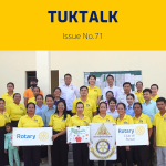 Workshop participants and TukTuk staff in yellow shirts hold Rotary Club of Pursat signs for a group photo