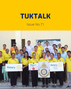 Workshop participants and TukTuk staff in yellow shirts hold Rotary Club of Pursat signs for a group photo