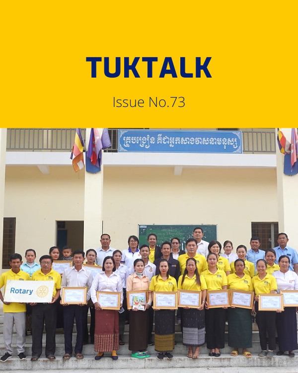 TukTalk 73 cover: teachers, officials and TukTuk staff hold framed certificates in front of a school building