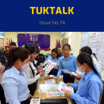 TukTalk 74 cover: teachers cut out and laminate classroom decorations at the CLIP3 kick-off workshop