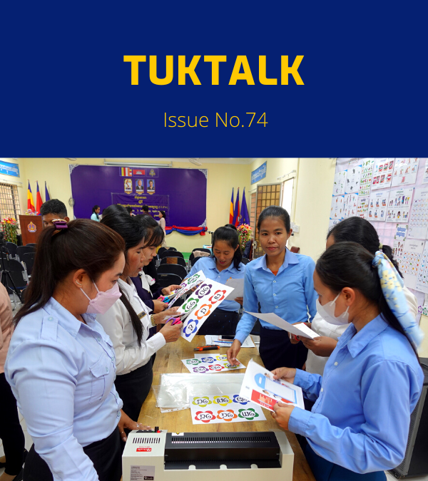 TukTalk 74 cover: teachers cut out and laminate classroom decorations at the CLIP3 kick-off workshop