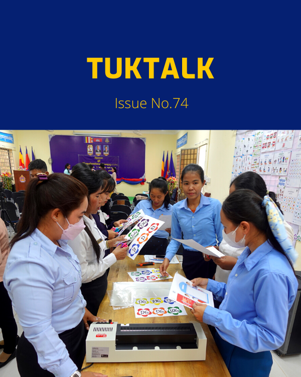 TukTalk 74 cover: teachers cut out and laminate classroom decorations at the CLIP3 kick-off workshop