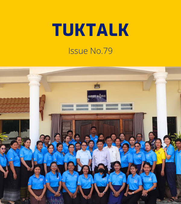 TukTalk 79 cover: dozens of teachers and officials in blue polo shirts pose in rows in front of a building