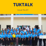 TukTalk 81 cover: dozens of teachers in blue polo shirts pose outside a building with a Rotary sign