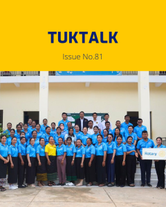 TukTalk 81 cover: dozens of teachers in blue polo shirts pose outside a building with a Rotary sign
