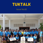 TukTalk 82 cover: a large group of teachers and officials pose outside a school with Rotary banners