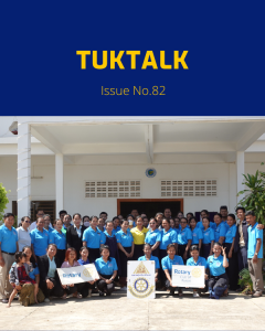 TukTalk 82 cover: a large group of teachers and officials pose outside a school with Rotary banners