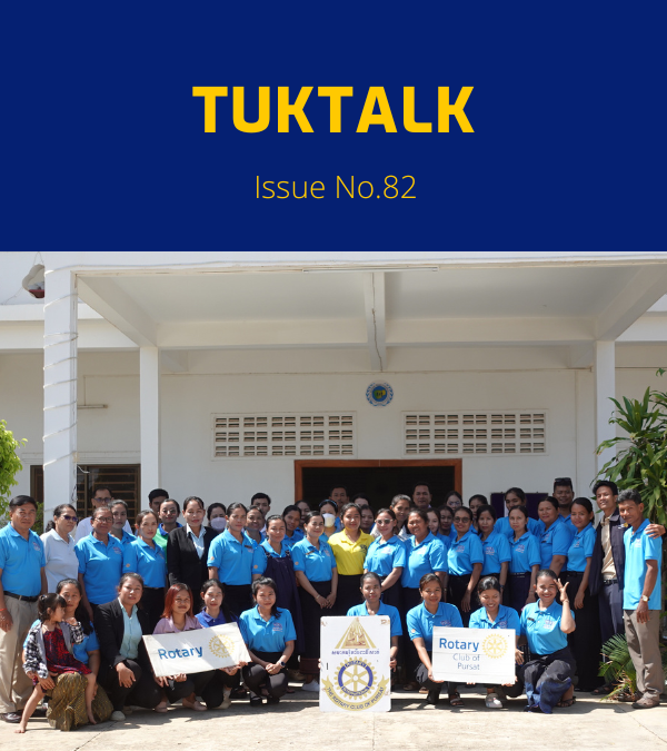 TukTalk 82 cover: a large group of teachers and officials pose outside a school with Rotary banners