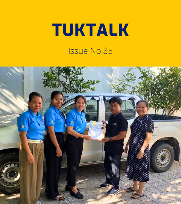 TukTalk issue 85 cover: TukTuk staff and visitors stand beside a pickup truck as documents are handed over