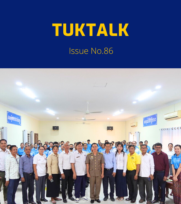 TukTalk issue 86 cover: officials, teachers and TukTuk staff pose together in a meeting hall after the CLIP3 annual meeting