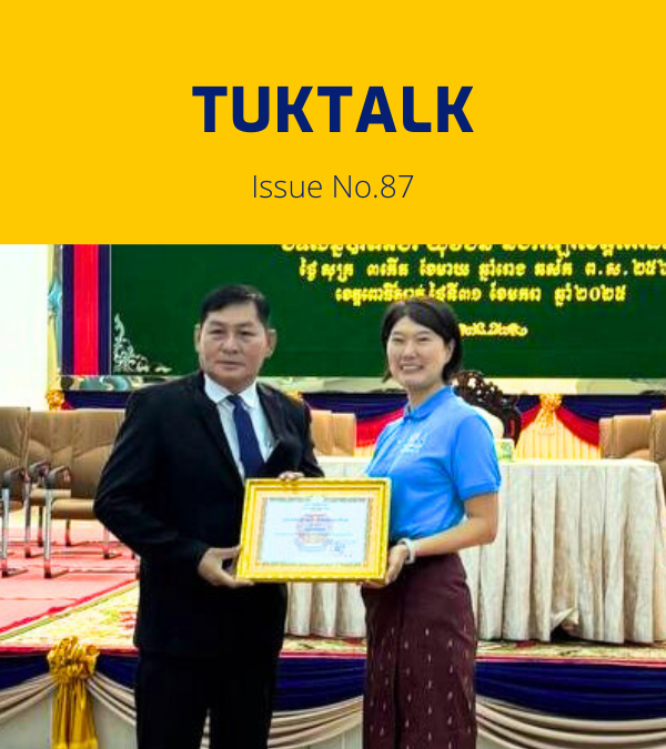 TukTalk issue 87 cover: a TukTuk staff member holds a certificate beside an official on stage at the provincial conference