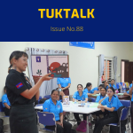TukTalk issue 88 cover: a presenter shows a picture-book illustration to teachers seated at tables in a workshop