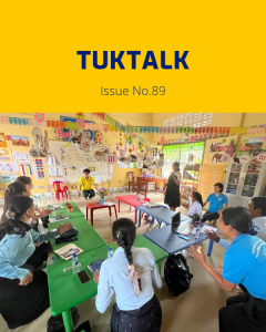 TukTalk issue 89 cover: teachers and TukTuk staff talk around green tables in a colourful classroom