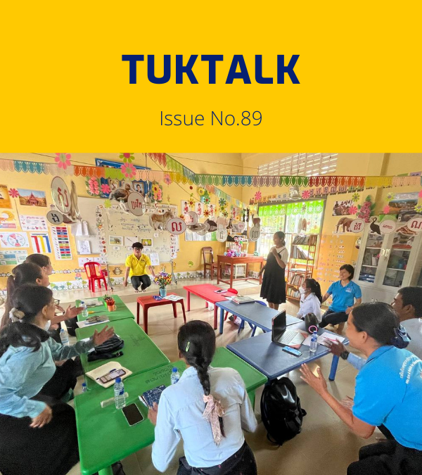 TukTalk issue 89 cover: teachers and TukTuk staff talk around green tables in a colourful classroom