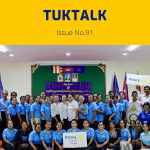 Teachers and guests pose for a group photo at the 6th workshop, holding a Rotary Club of Pursat sign