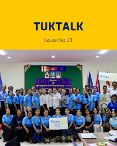 Teachers and guests pose for a group photo at the 6th workshop, holding a Rotary Club of Pursat sign
