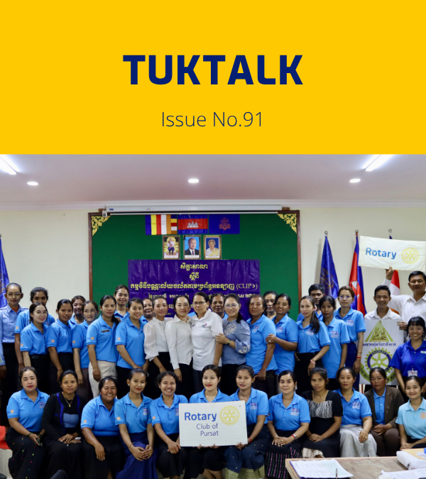 Teachers and guests pose for a group photo at the 6th workshop, holding a Rotary Club of Pursat sign