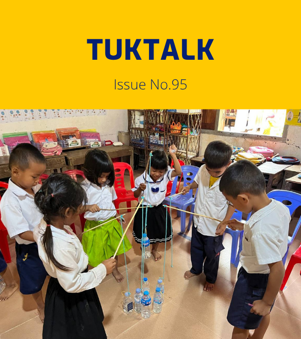 Preschool children play with sticks, string and water bottles in a classroom activity
