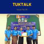 TukTuk staff pose with a certificate beside a banner at the CLIP3 closing meeting