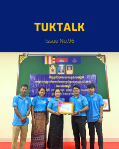 TukTuk staff pose with a certificate beside a banner at the CLIP3 closing meeting