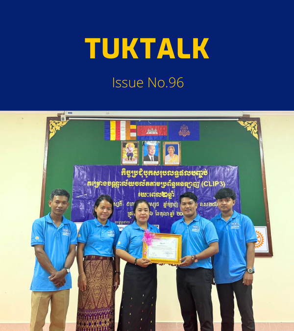TukTuk staff pose with a certificate beside a banner at the CLIP3 closing meeting