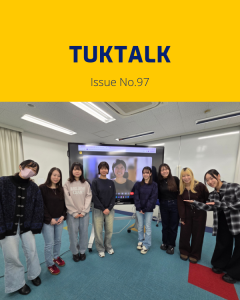 TukTalk issue 97 cover above a photo of university students posing in a classroom beside a screen