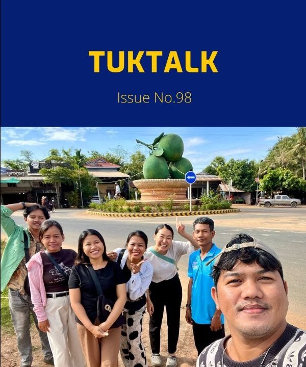TukTalk issue 98 cover above a selfie of TukTuk staff and friends posing beside a roundabout monument